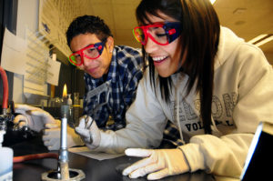 Two high school students conducting a science experiment